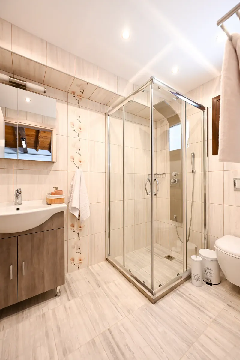 A shower room in stone and glass