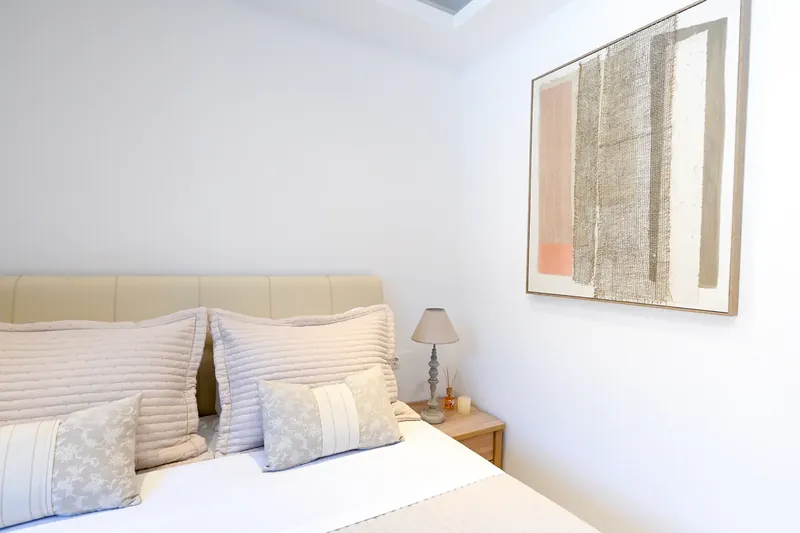 Cushions on a made bed