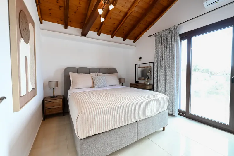 A bedroom with a view out to the garden