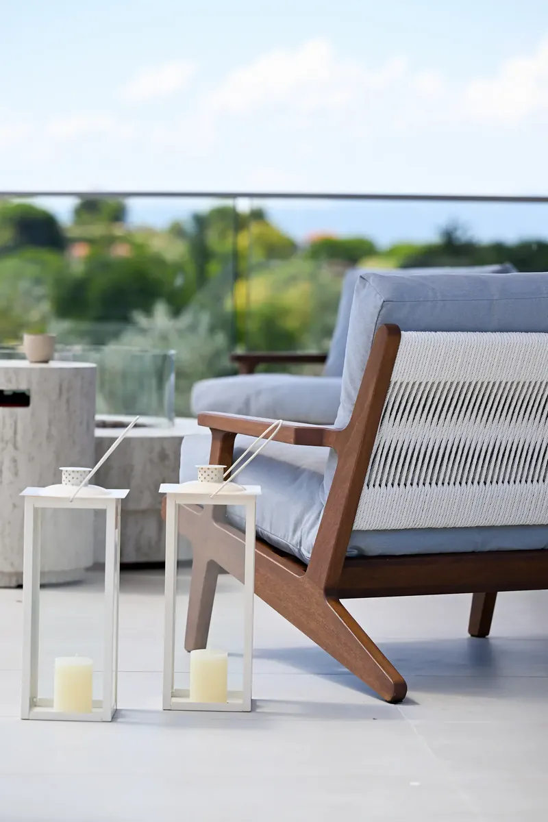 A chair on the terrace, looking into the olive grove