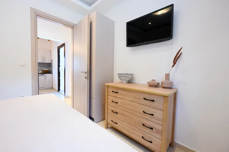 A chest of drawers and the television
