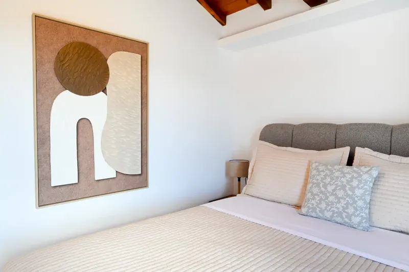 A day bed below a framed print
