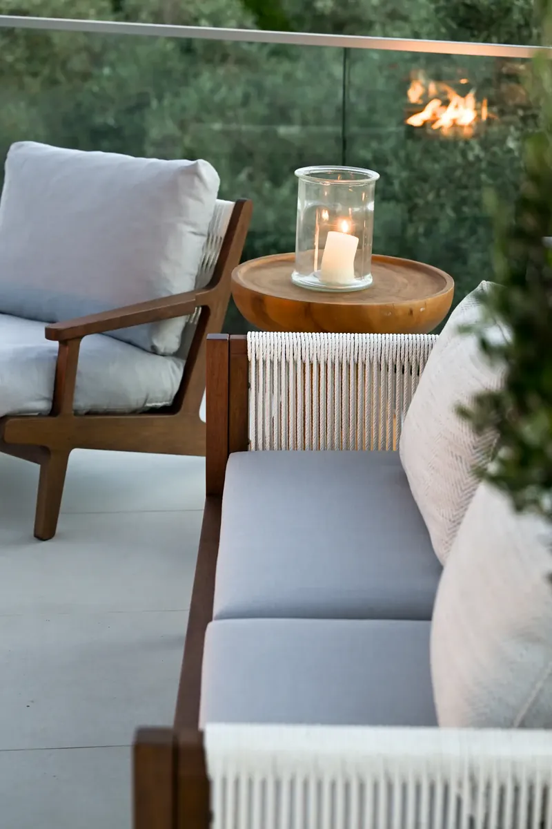 A lantern on the side table beside an armchair