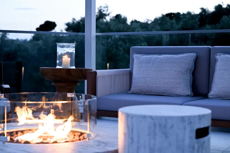 The outdoor sofa and the fire, with the olive trees behind
