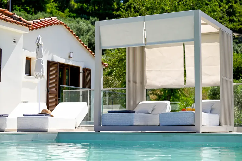 Loungers and a canopy beside the pool