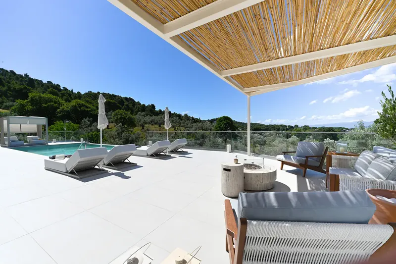 The shaded lounge under the pergola, looking over the pool