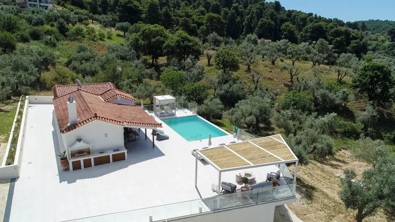 The pool and the house from above, with the hills behind