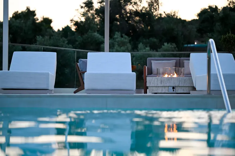Chairs at the poolside as the light goes