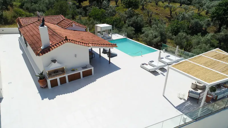 The sun terrace and loungers beside the water